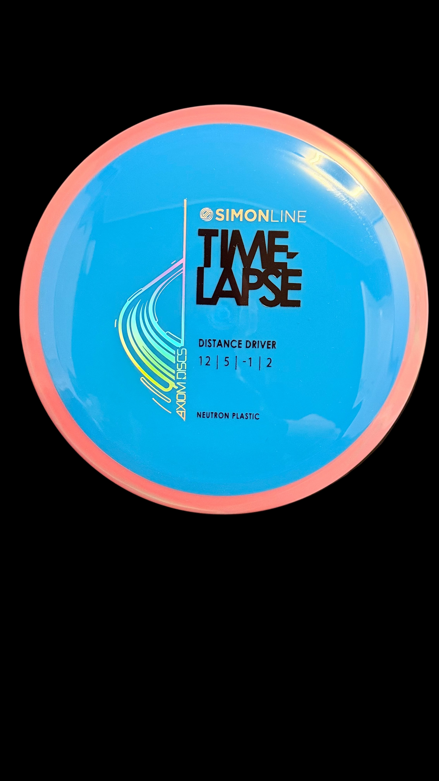 Axiom Neutron Time-Lapse distance driver in blue with a pink rim, Simon Line stamp, flight numbers 12 | 5 | -1 | 2, displayed on a stand