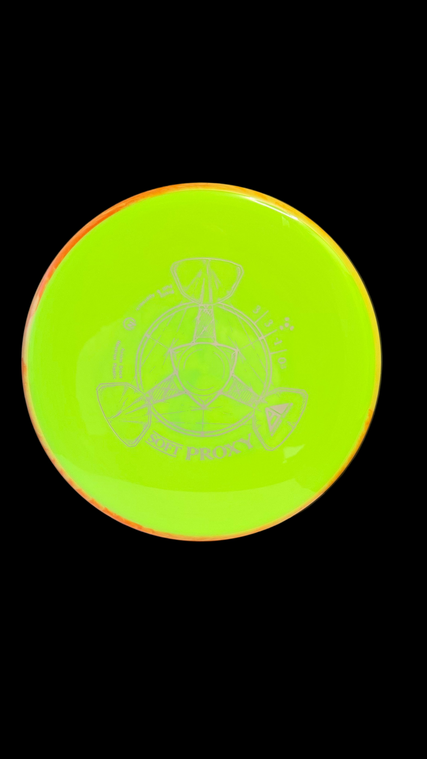 Neon yellow Axiom Soft Proxy disc golf putter with an orange rim and white line-art stamp displayed on a white surface.