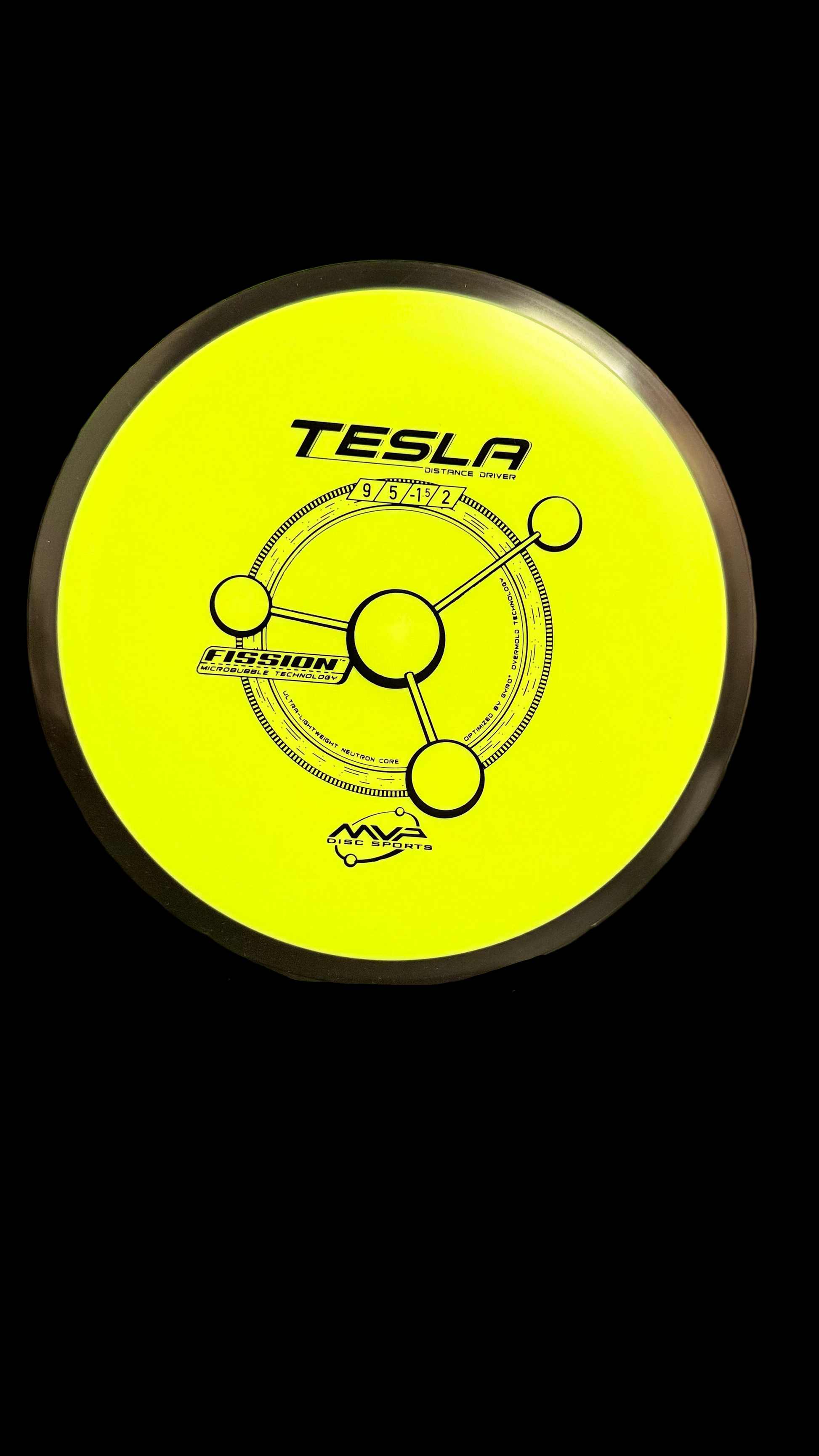 A bright-yellow MVP Fission Tesla distance driver with a dark rim, featuring the Tesla orbital stamp and flight numbers 9 | 5 | -1 | 2 on a stand.