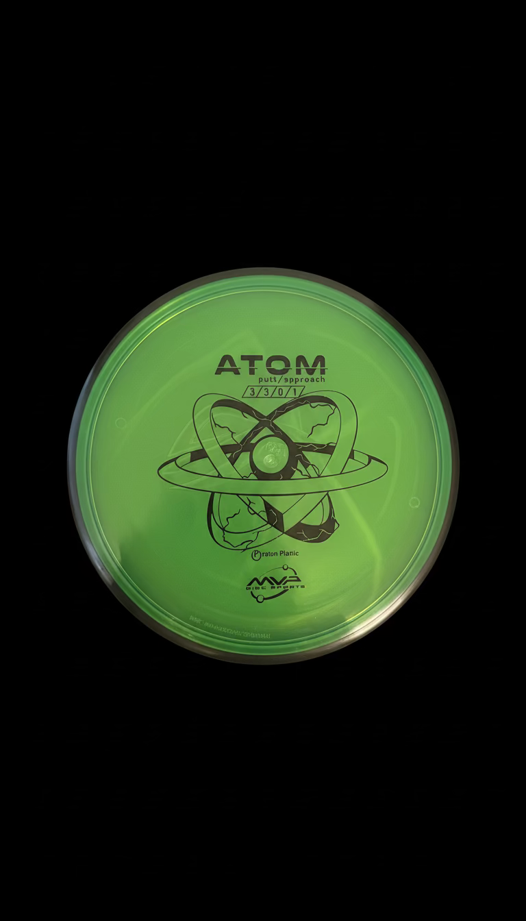 Green MVP Proton Atom putt and approach disc with a black rim and black atomic-style graphic stamp.