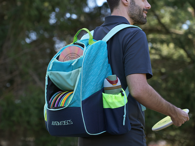 Axiom Shuttle Bag in Olive, Tropic Blue, and Golden Yellow — durable 900D polyester disc golf backpack.