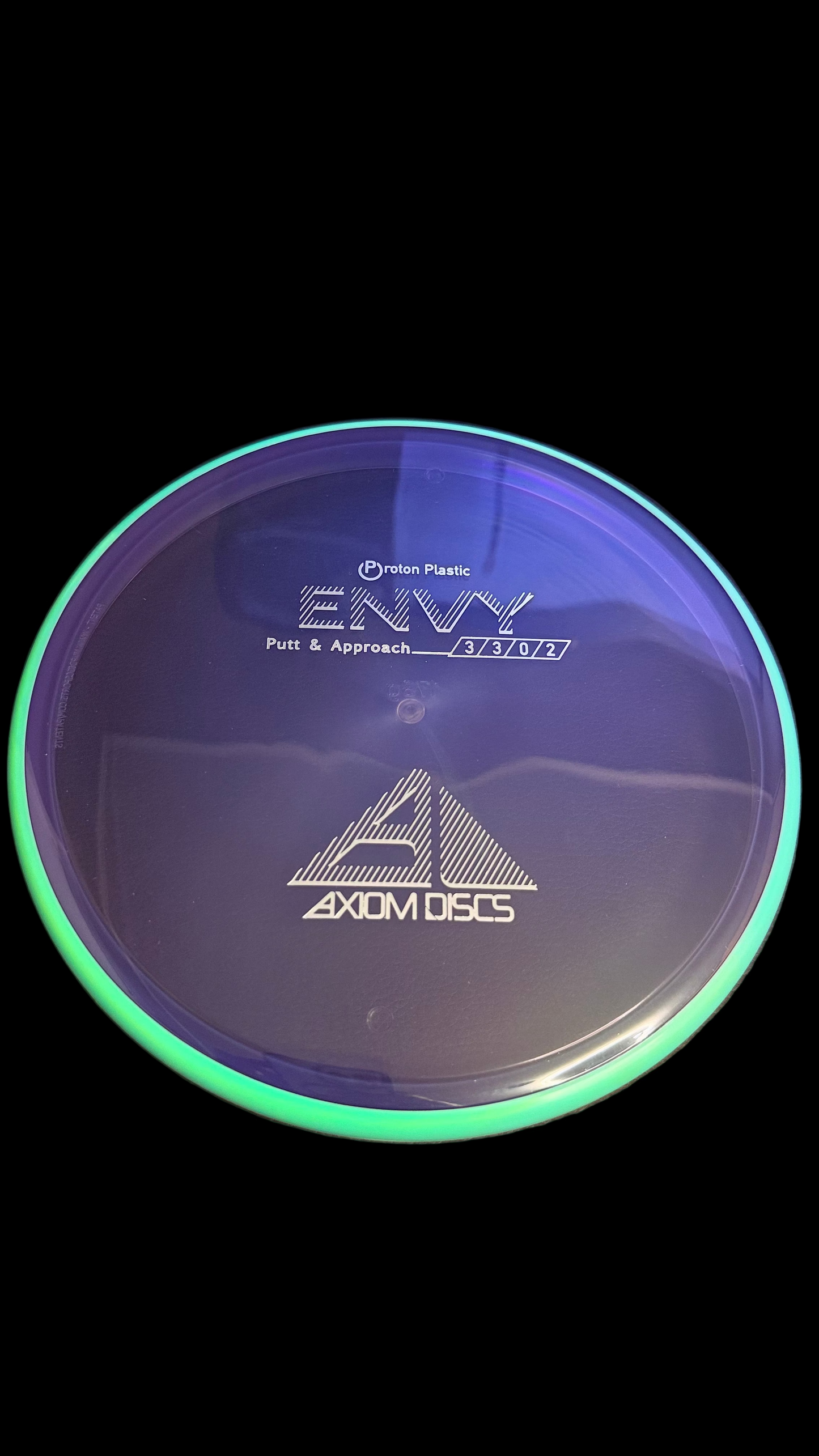 Axiom Electron Envy putter disc in translucent purple with mint green rim, top view showing flight ratings 3|3|0|2 and Axiom Discs logo
