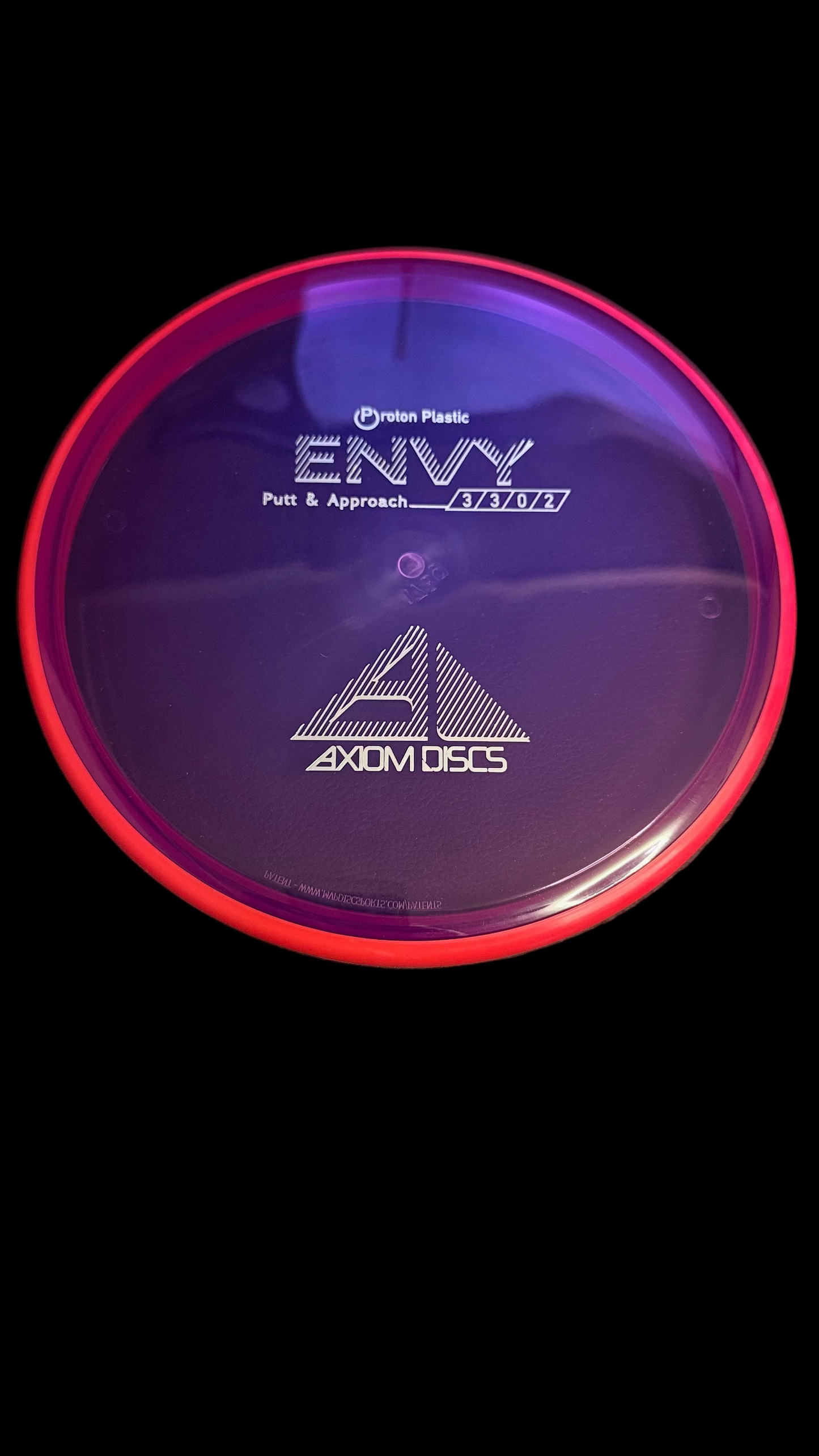 Axiom Electron Envy putter disc in translucent purple with pink-red rim, top view showing flight ratings 3|3|0|2 and Axiom Discs logo
